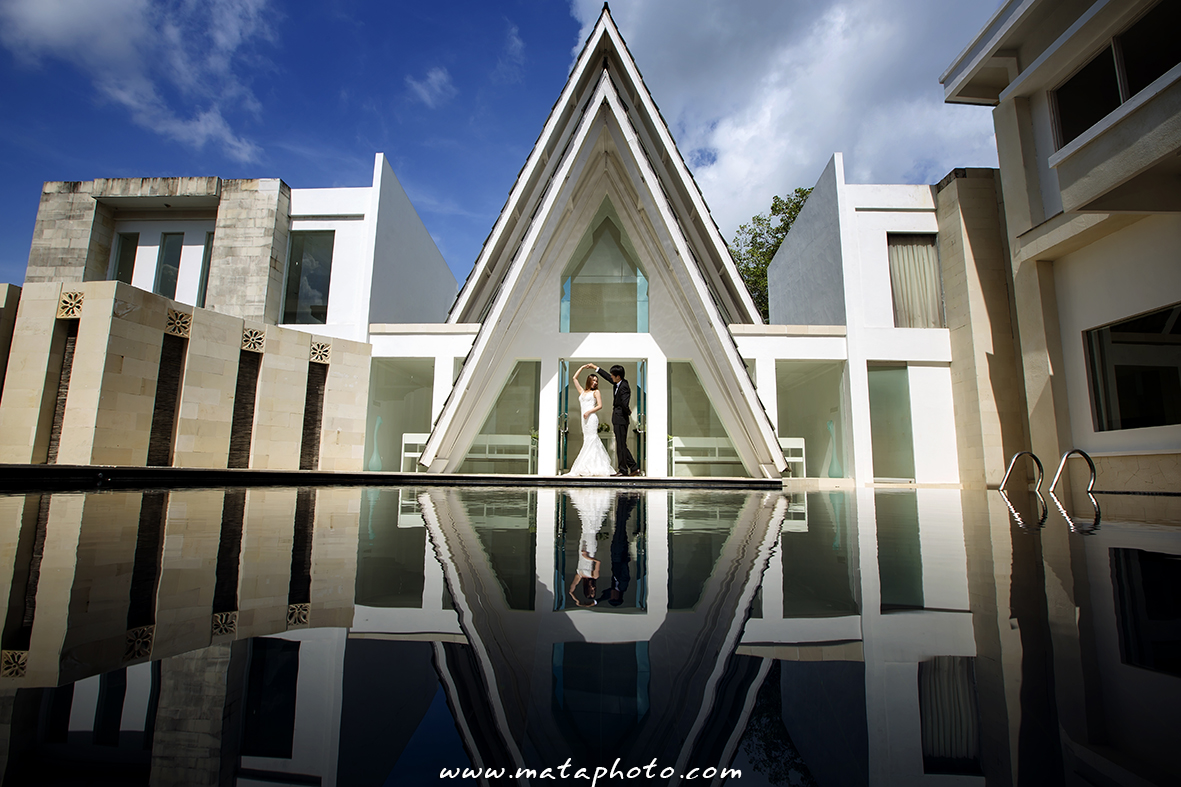 Amanda Chapel's white triangular glass facade reflected in the still pond in front of it, Tuban, Kuta, Bali