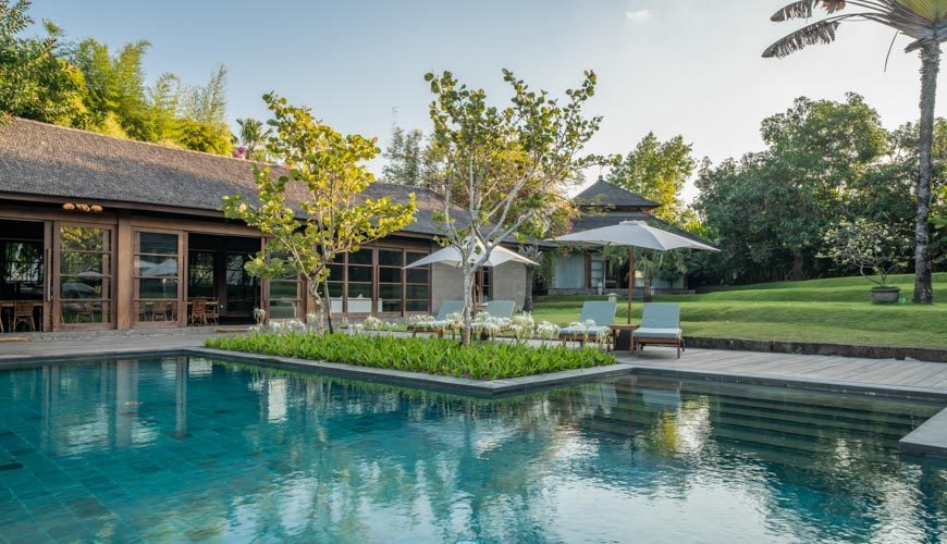 The 25-metre pool and lawn at Amita Villa in the Kerobokan rice fields near Canggu, Bali