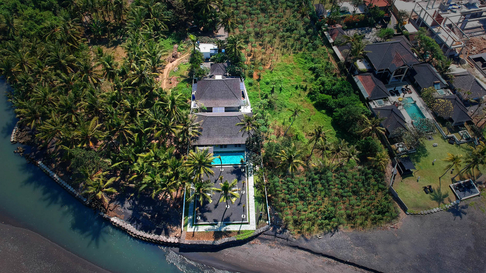 The beachfront garden and pool at Biara Villa on Saba Beach in Ketewel, with the open living pavilion and ocean views