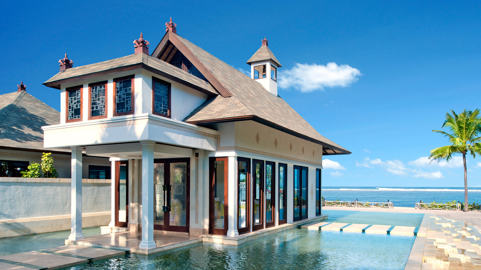 Cloud Nine Chapel at The St. Regis Bali, a glasshouse chapel set over a reflecting pond beside the beach in Nusa Dua