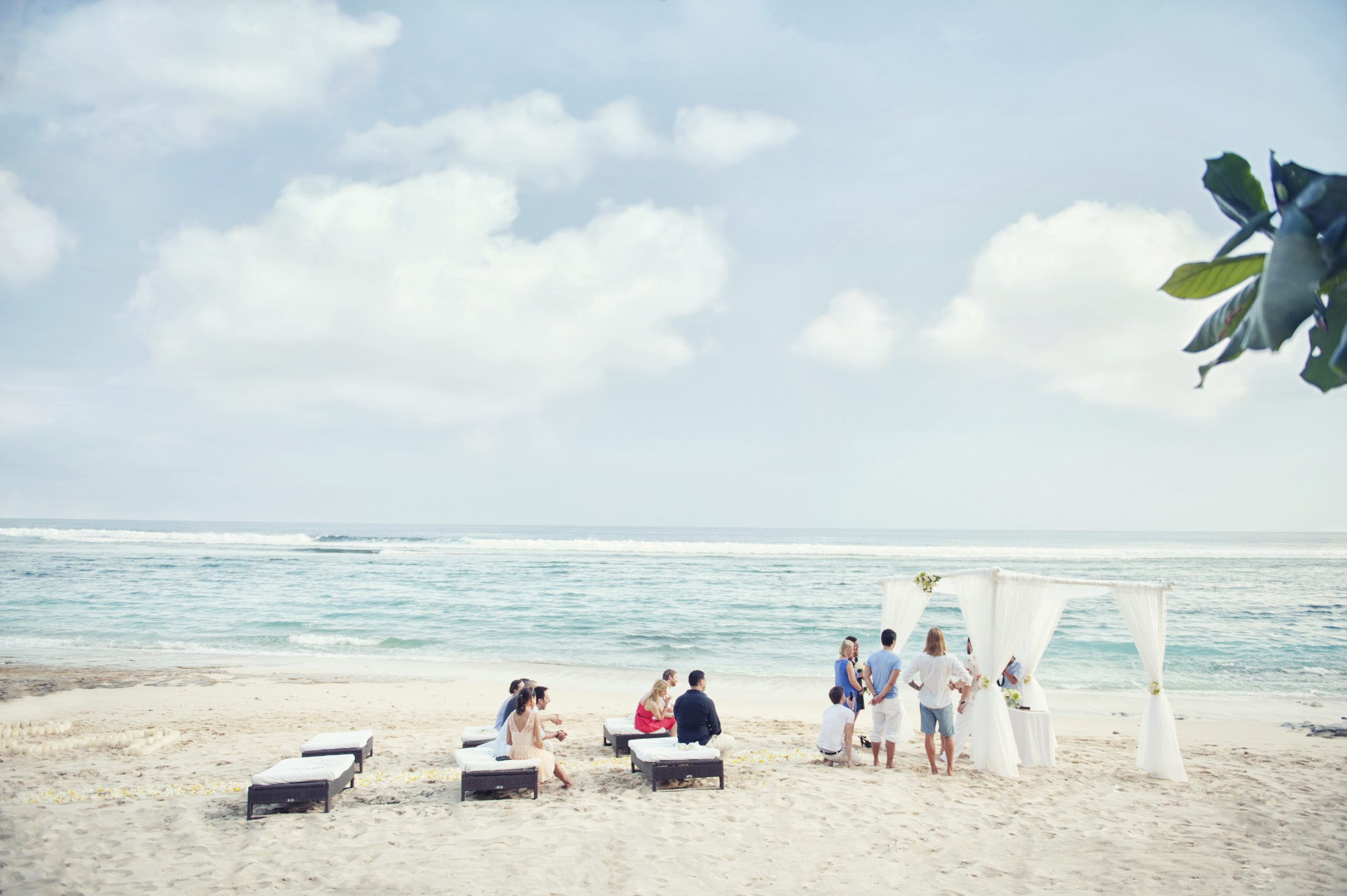 Beachfront wedding setting on the sand below the clifftop resort at Karma Kandara, Ungasan, Bali
