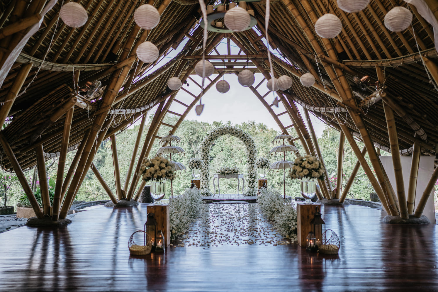 The bamboo Puspaka Sky Wedding Chapel at The Kayon Jungle Resort, set for a ceremony with a floral arch over the jungle valley near Ubud