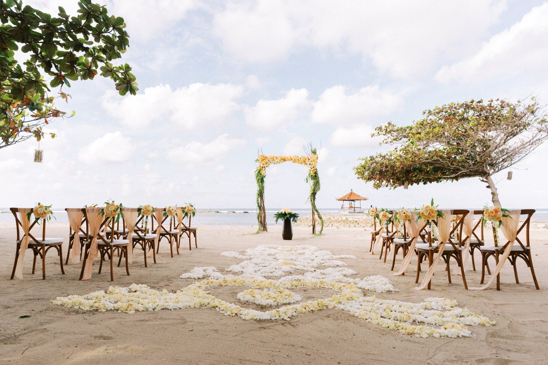 Wedding couple on the private beach at Kayumanis Nusa Dua with the ocean behind