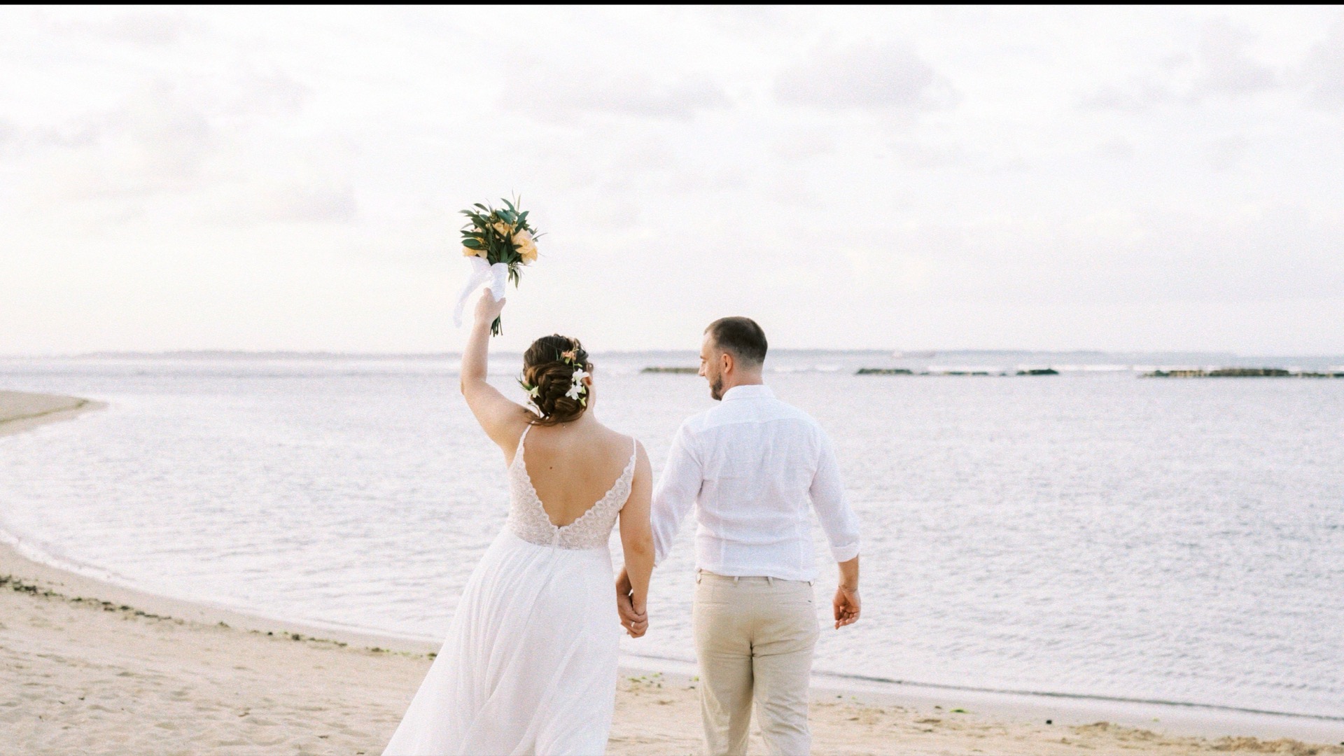 A beach wedding ceremony set up on the private white-sand beach at Kayumanis Nusa Dua, Bali