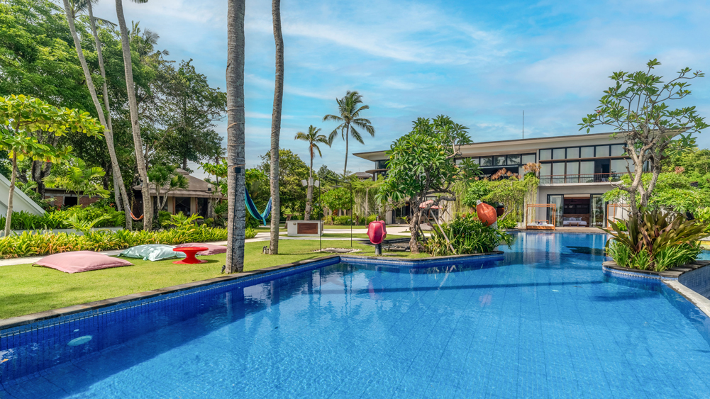 Beachfront lawn and pool at Kiss Bali Beach Residence on Cemagi Beach, Canggu area