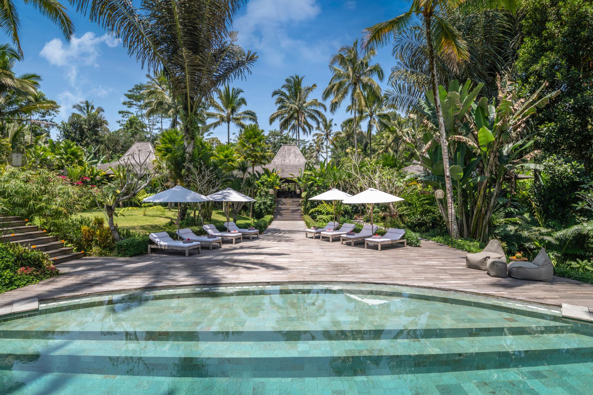 The main pool and joglo pavilions at Villa Nag Shampa, surrounded by tropical jungle north of Ubud