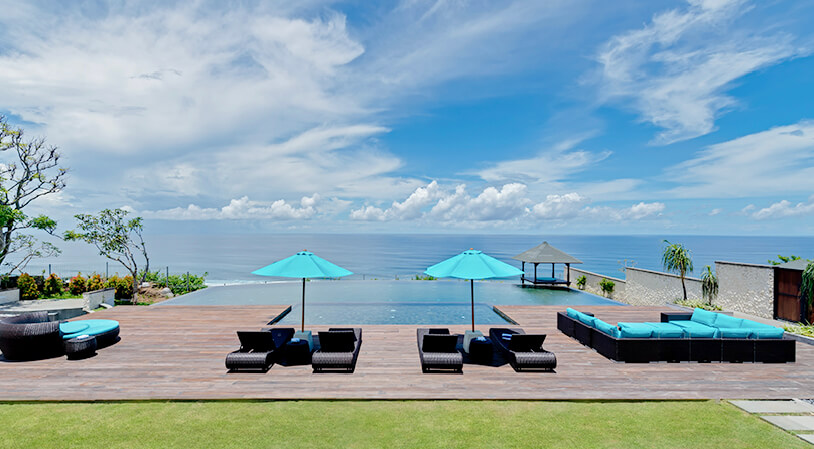 The Pala infinity pool running out toward the ocean horizon at Pandawa Cliff Estate above Pandawa Beach, Bali