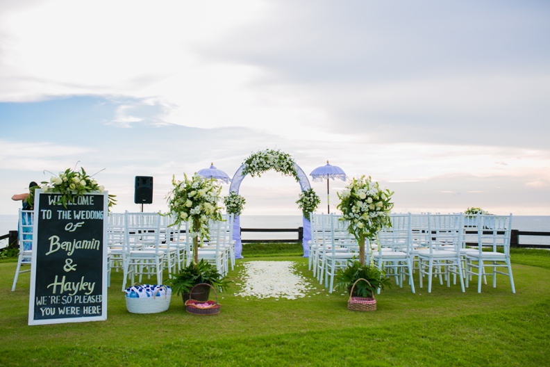 Wedding ceremony inside Santi Chapel at The Kunja Villas in Seminyak, guests seated either side of the aisle facing the altar