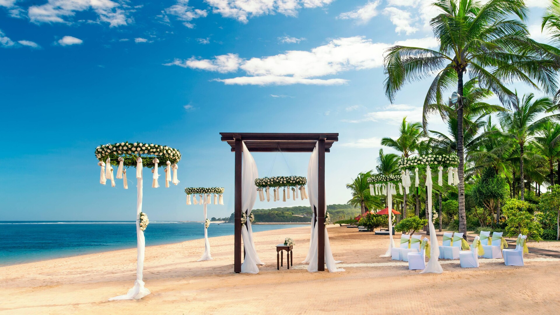 A beach wedding ceremony on the white sand at The St. Regis Bali Resort