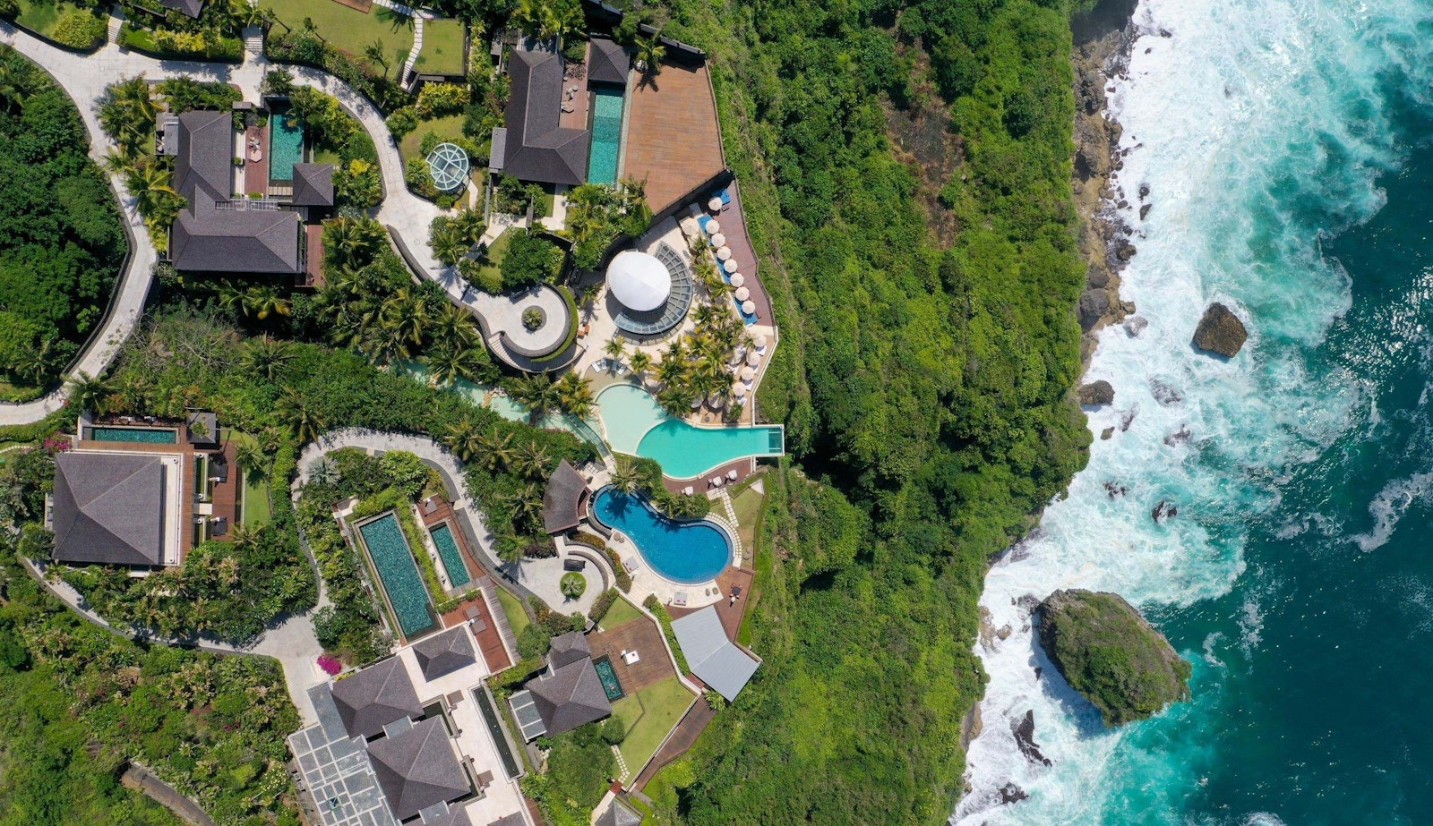Aerial view of The Edge cliffside resort and its cantilevered deck over the Indian Ocean in Pecatu, Uluwatu