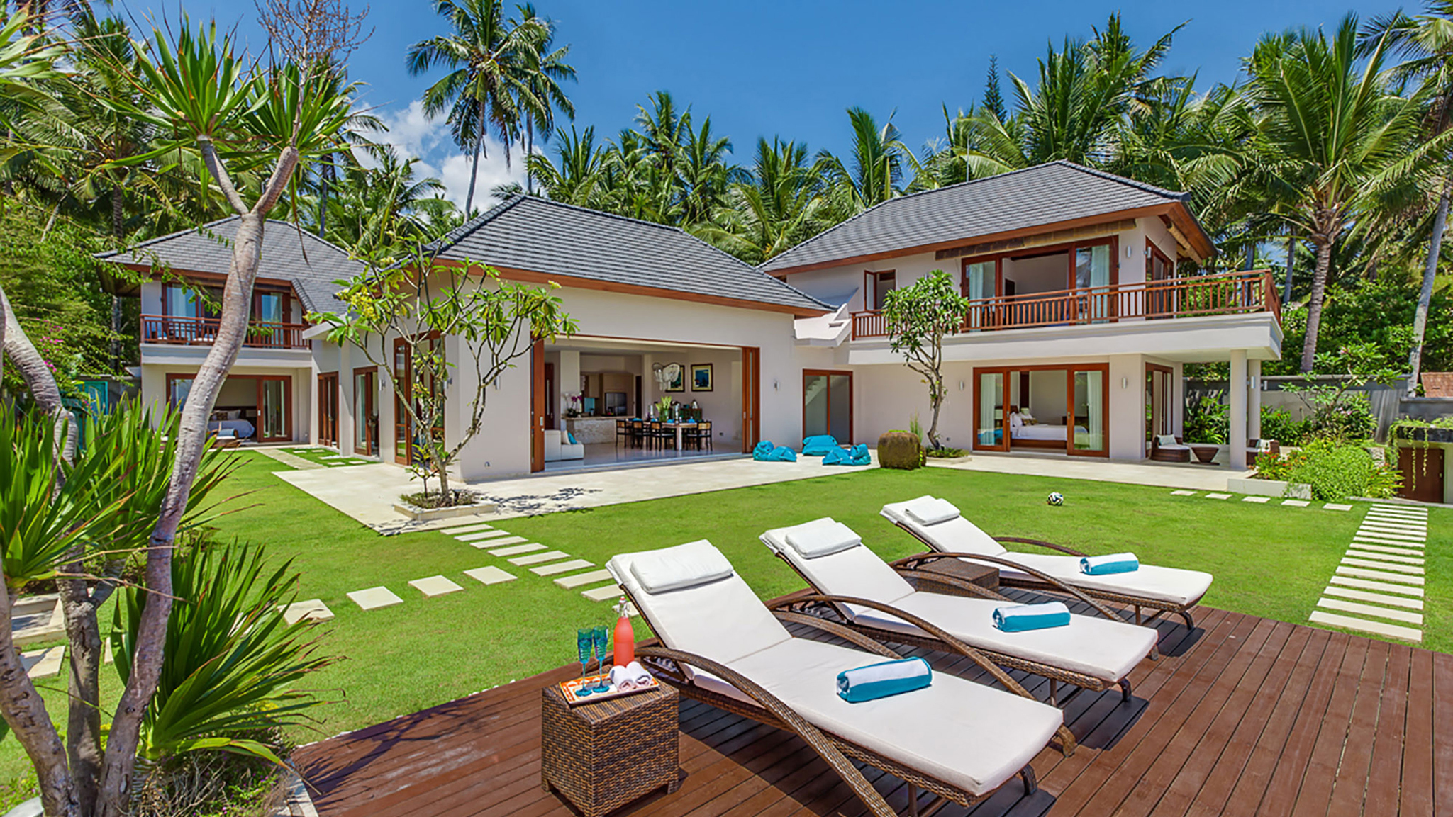 Pool deck and villa exterior at Tirta Nila Beach House, beachfront property near Candidasa
