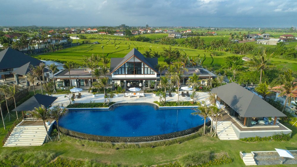 Aerial view of Tirtha Bayu Estate from the ocean, above the black-sand beach at Cemagi on the Seseh and Tanah Lot coast