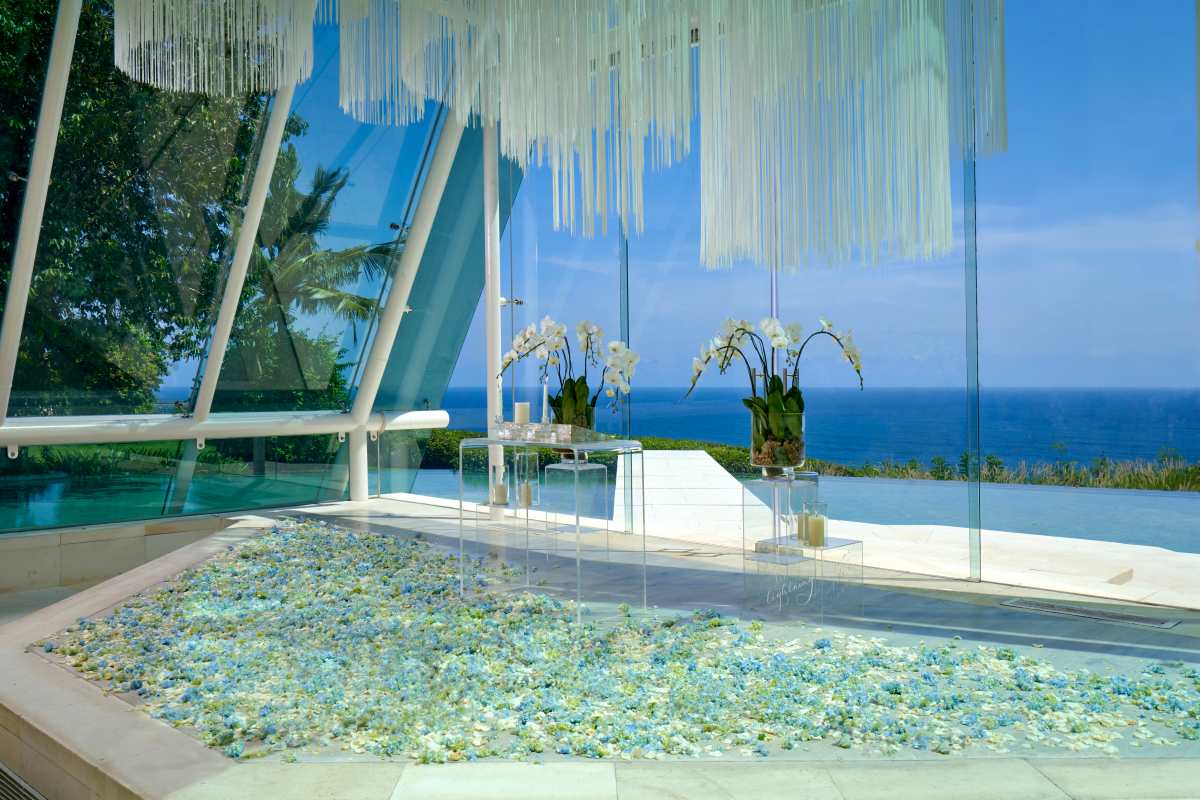 Light filling the glass chapel interior at Tirtha Uluwatu