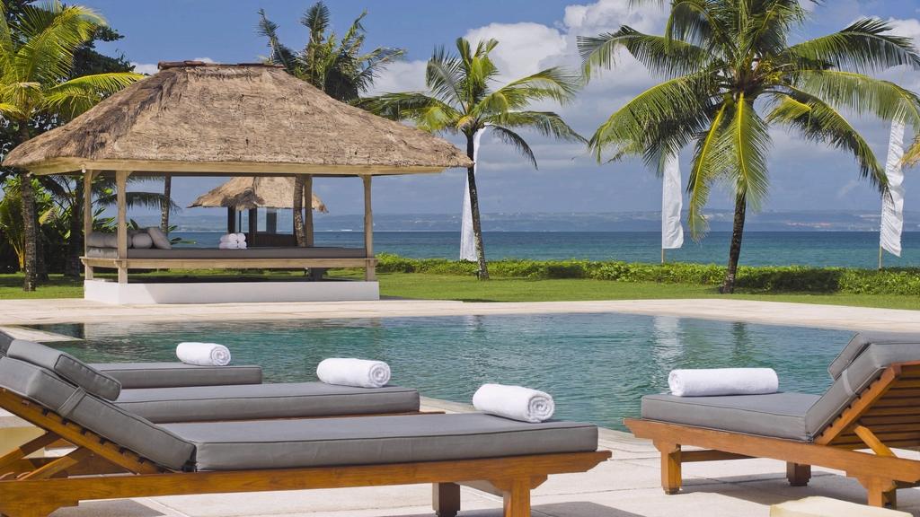 The outdoor pool and deck at Villa Atas Ombak, an absolute beachfront villa in Seminyak