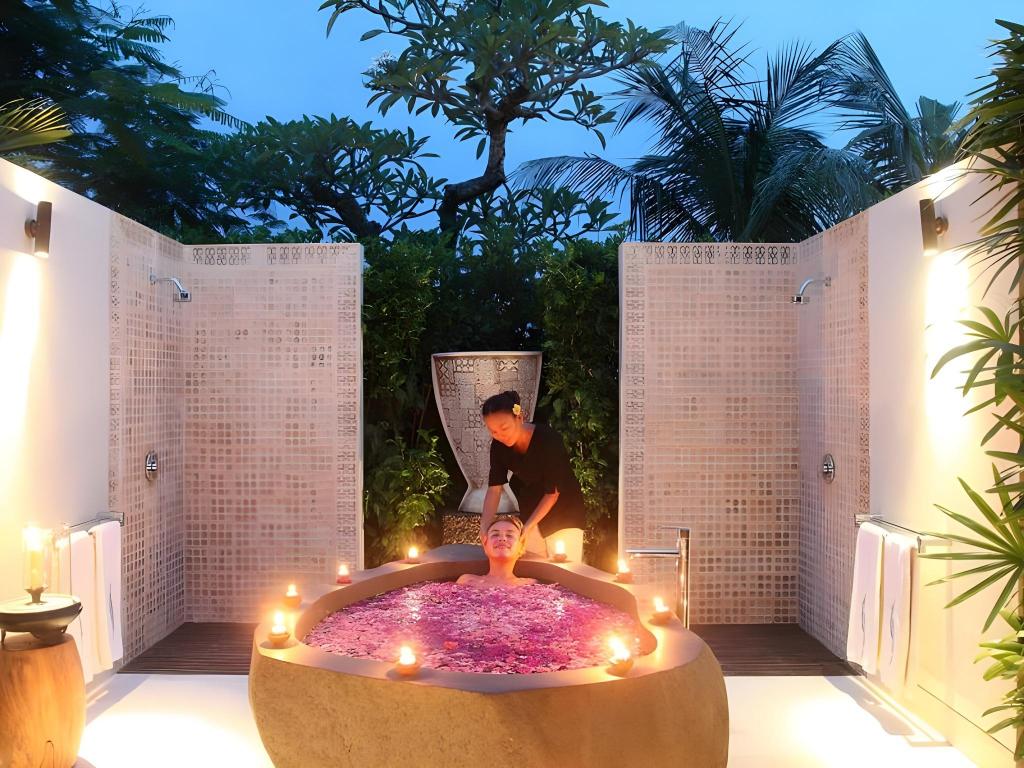 Villa Cahaya's private spa pavilion, set up for an outdoor massage beside the lava-stone bathtub