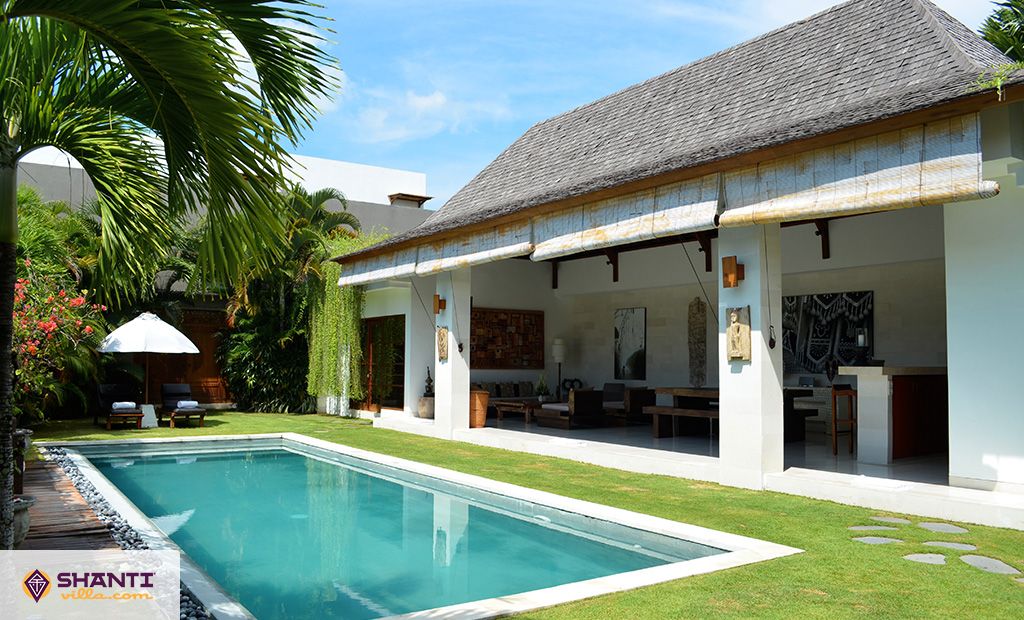 Villa Chocolat's pool, lawn, and open living pavilion in the Oberoi area of Seminyak, Bali