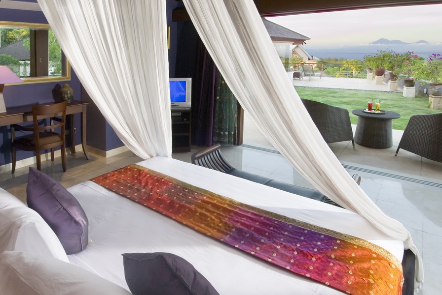 Bedroom at Villa Indah Manis opening onto a terrace with an Indian Ocean view