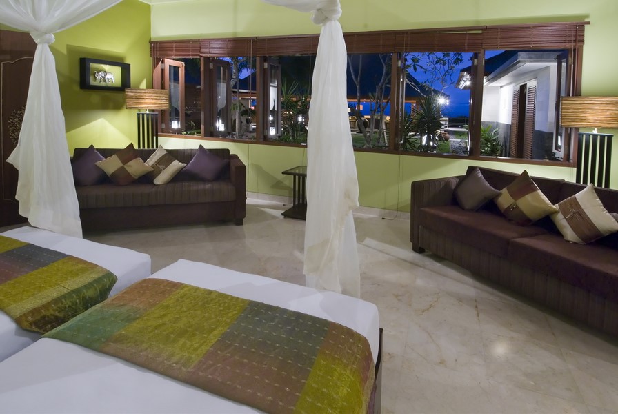 Living and media room at Villa Indah Manis with sofas and garden view windows