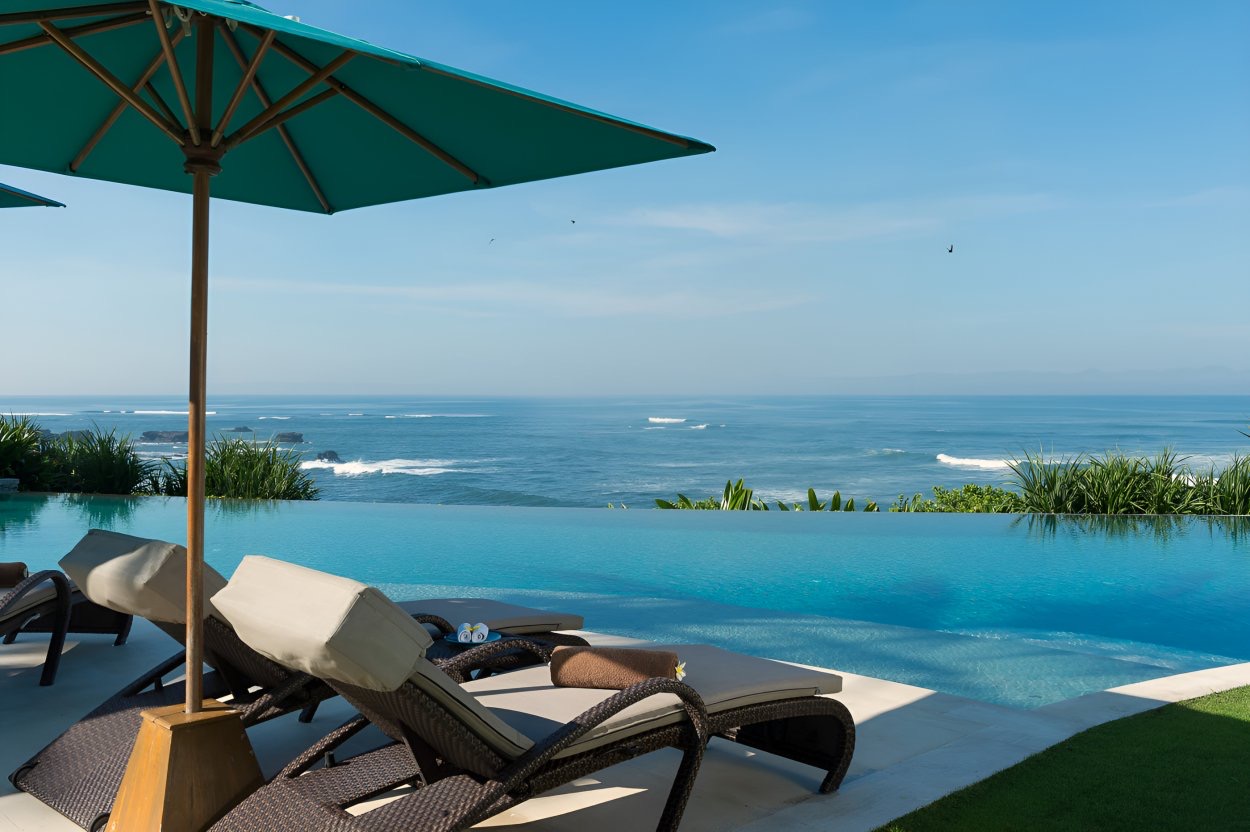 Villa Jagaditha's 20 metre infinity pool and lawn facing the Indian Ocean on the Seseh coast near Canggu