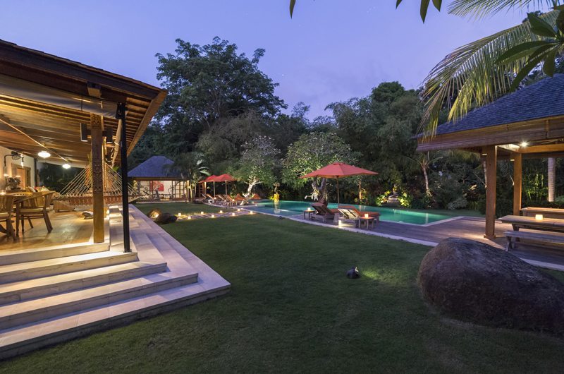 Villa Kavaya's lawn and pool in Pererenan surrounded by rice fields and tropical gardens, Canggu