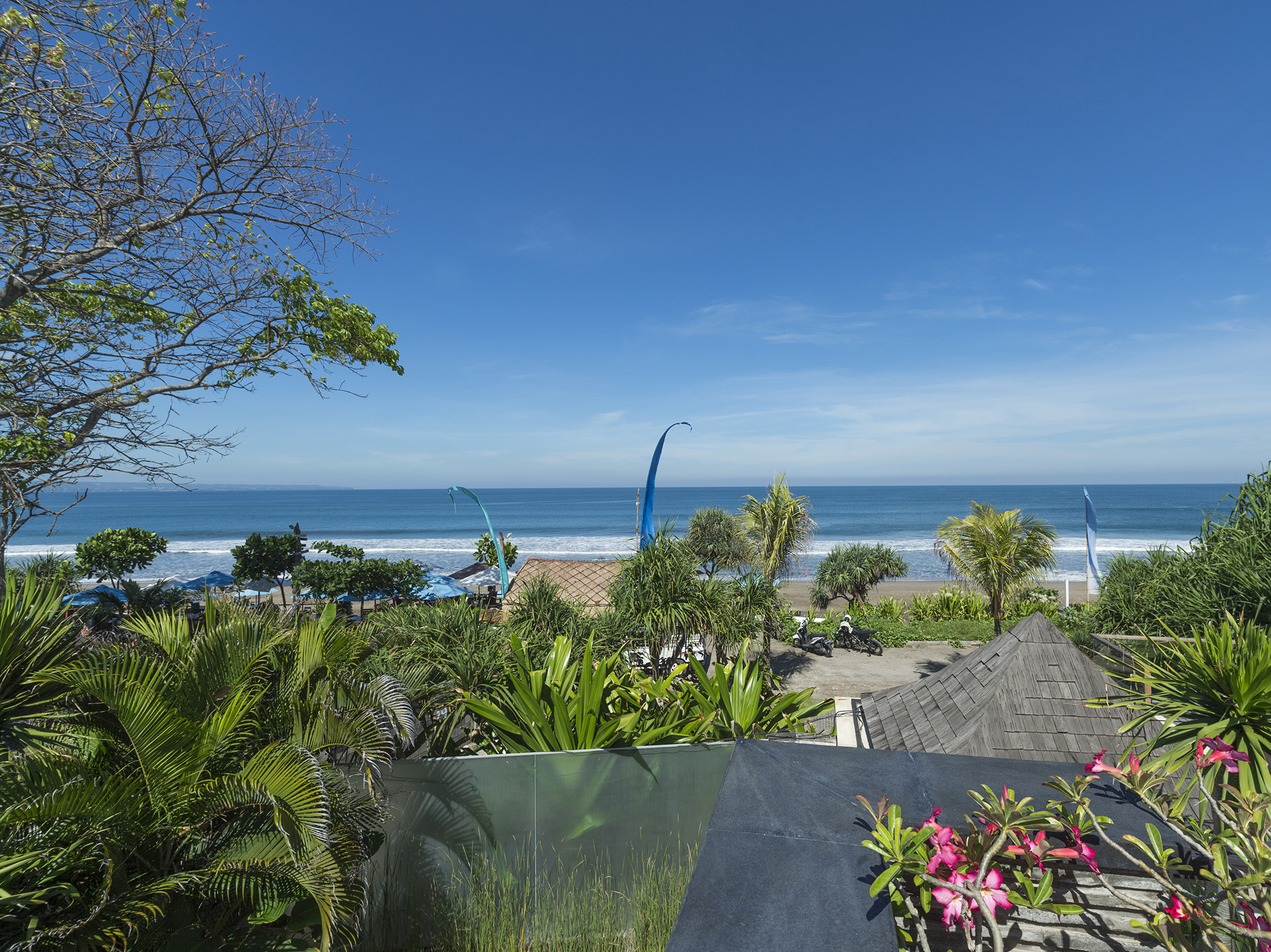 View from Villa LeGa over its tropical garden to Batu Belig Beach and the ocean, northern Seminyak
