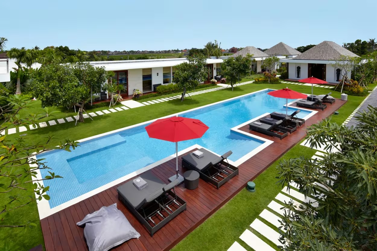 Villa Malaathina's long pool and lawn in front of the villa's pavilions, Umalas near Seminyak, Bali