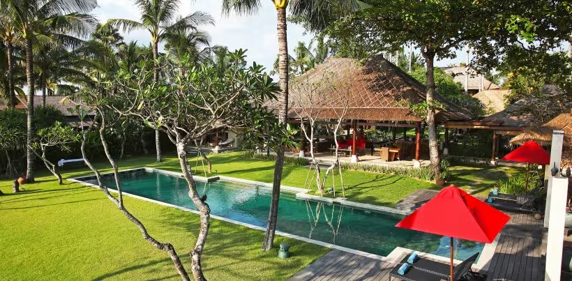 Villa Maridadi in Cemagi with its long greenstone pool, garden, and thatched pavilions near the beach