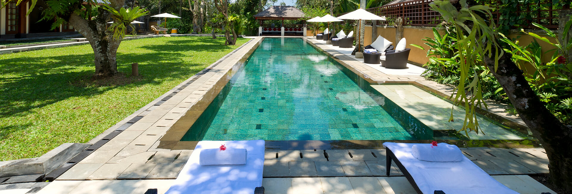 The 25-metre lap pool at Villa San in central Ubud, framed by open pavilions and tropical garden