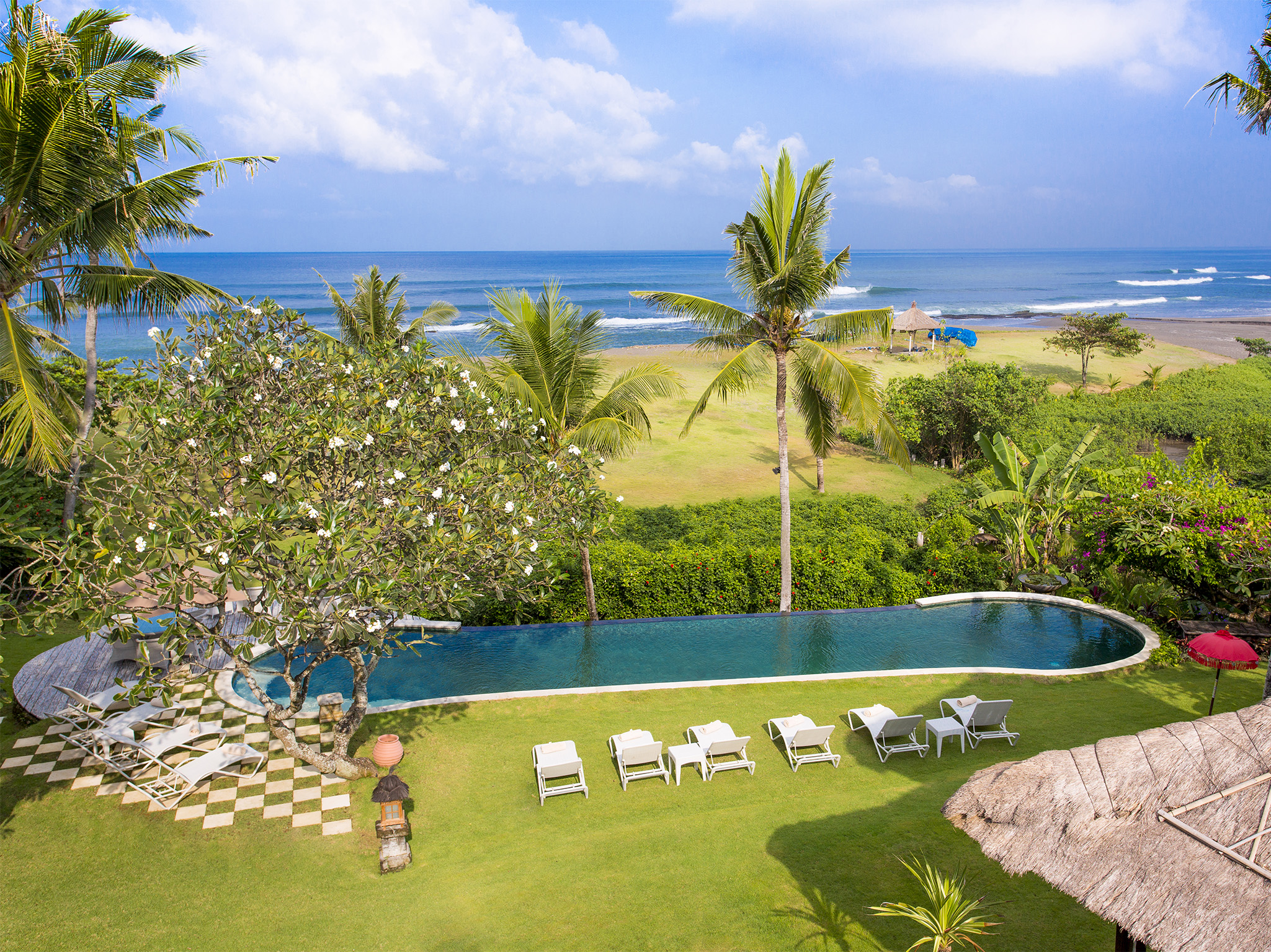Villa Sungai Tinggi's oceanfront pool with dramatic beach and ocean views, Canggu's beachfront venue