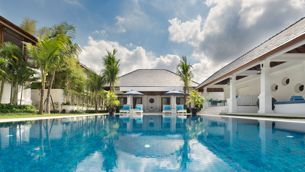 Villa Windu Asri's long swimming pool between the villa's pavilions under a bright sky, Petitenget Seminyak