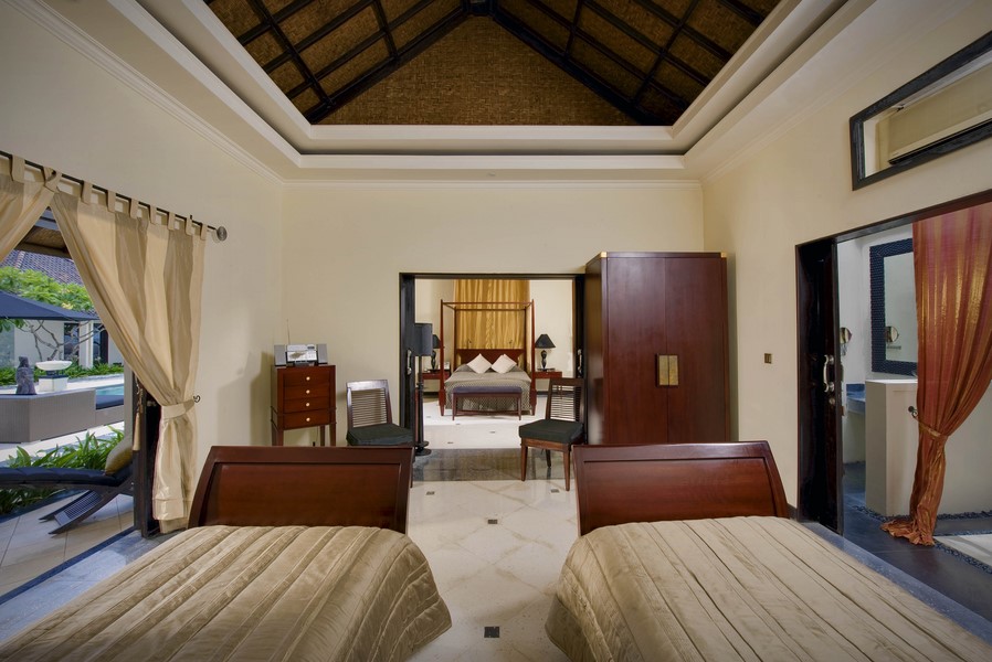Two-storey atrium living pavilion at Villa Ylang Ylang with staircases and lounge seating