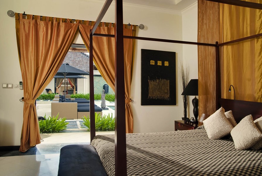 Bedroom opening onto the pool terrace at Villa Ylang Ylang
